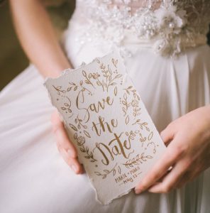 Bride holding one of our handmade save the date cards