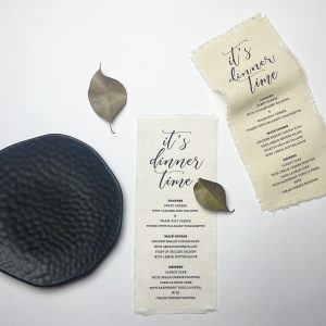 Cotton fabric menu with custom printed black wording in 4.25 inches x 9.50 inches