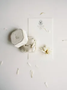 Picture features luxury custom debossed velvet fabric engagement ring box as offered on the website of DennisWisser.com