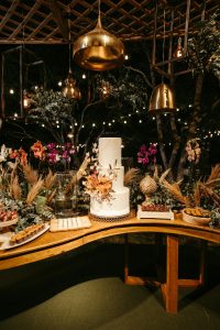 Rustic wedding table decoration with sculptures, vases and country style flower decoration