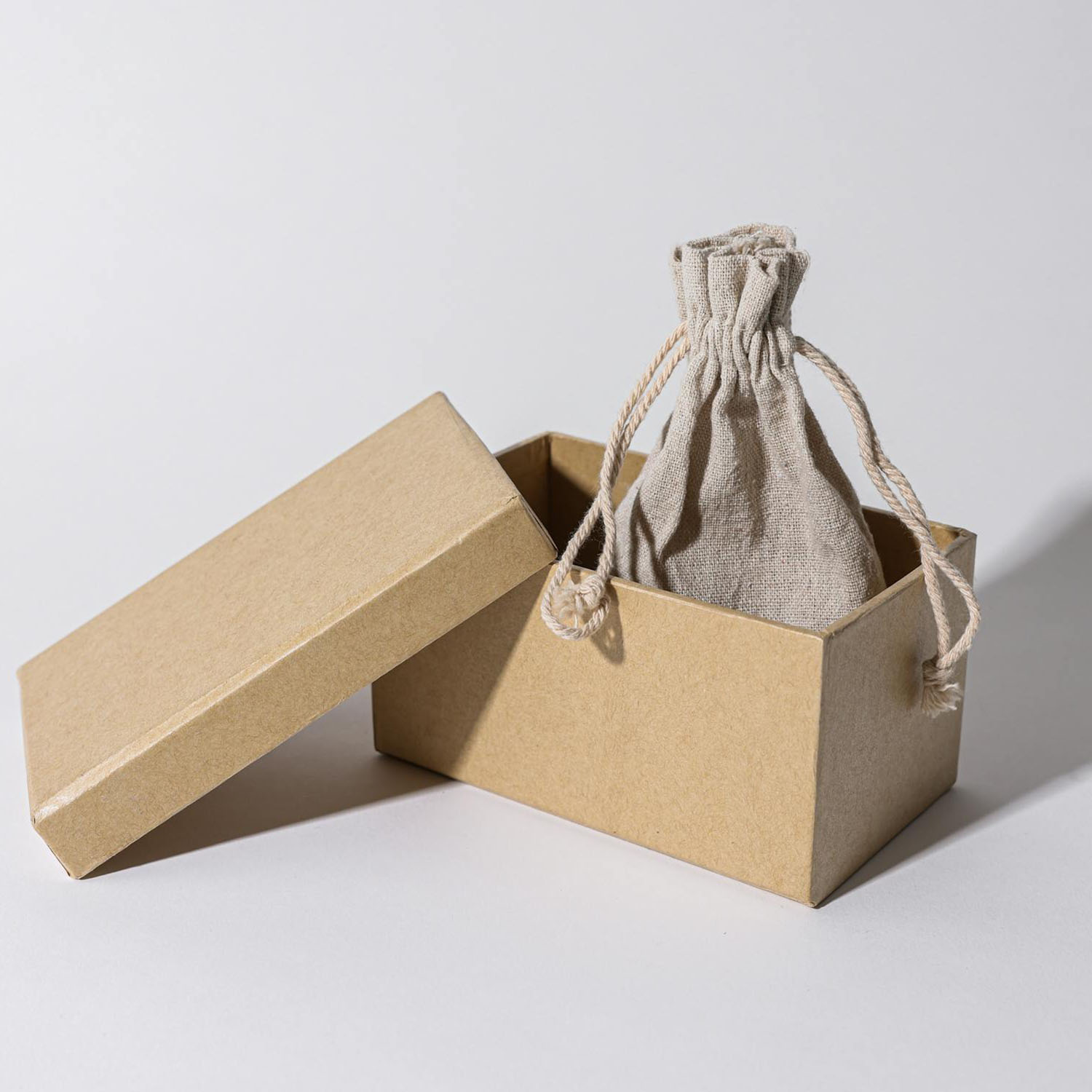 Eco-friendly packaging manufacturer, Thailand Eco-friendly kraft paper rigid box with linen drawstring bag from Chiang Mai, Thailand