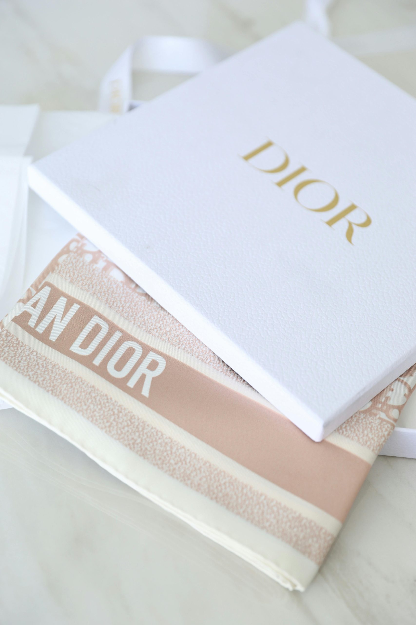 Luxury white rigid box from Dior with foil stamped logo