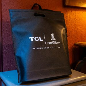 Black non-woven fabric tote bag with white logo print